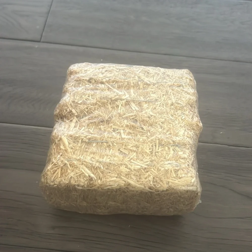 Scarecrow figurine with straw Bale